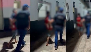 Suspeito chegando à delegacia no domingo. — Foto: Suspeito chegando à delegacia