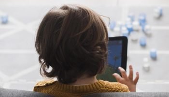 back-view-kid-holding-tablet-1
