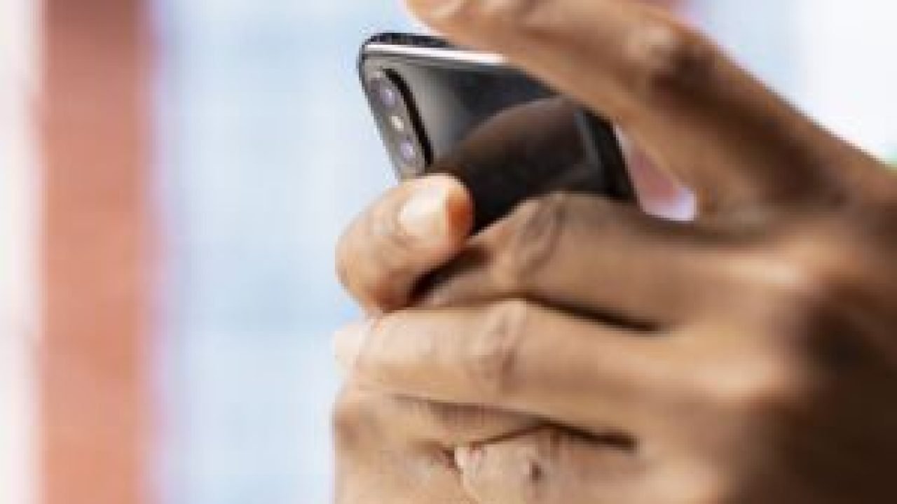 man-home-using-smartphone-catch-up-with-emails-reply-back-closeup